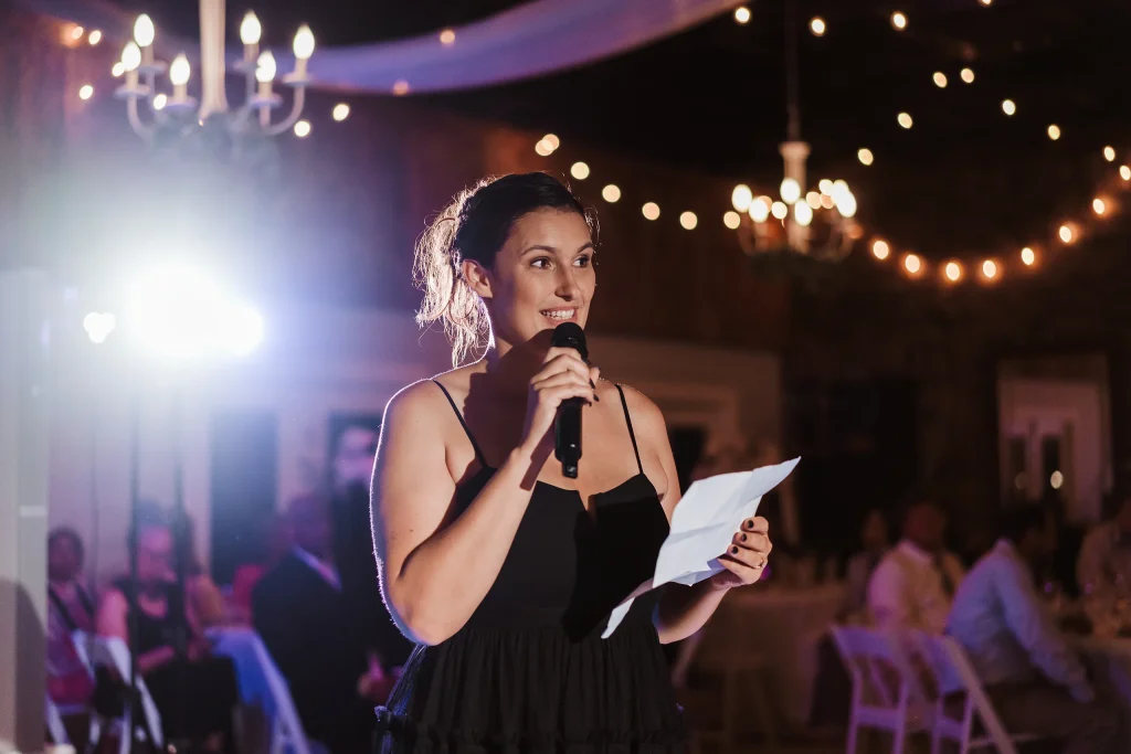 The maid of honor gives a heartfelt speech during the wedding reception at Masters Stables.